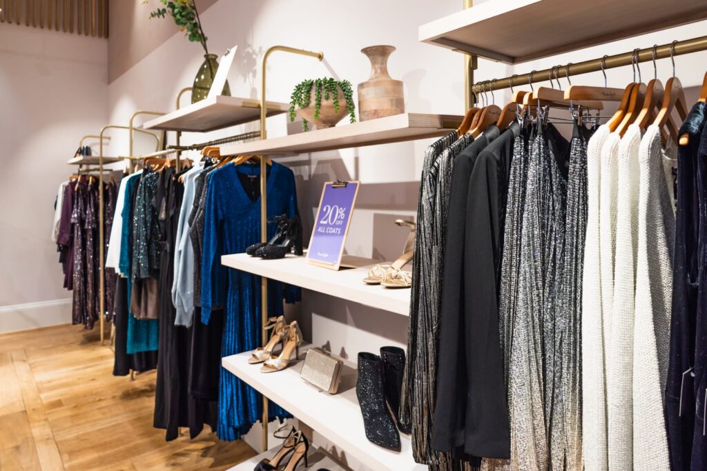 Retail store with racks of clothing on display